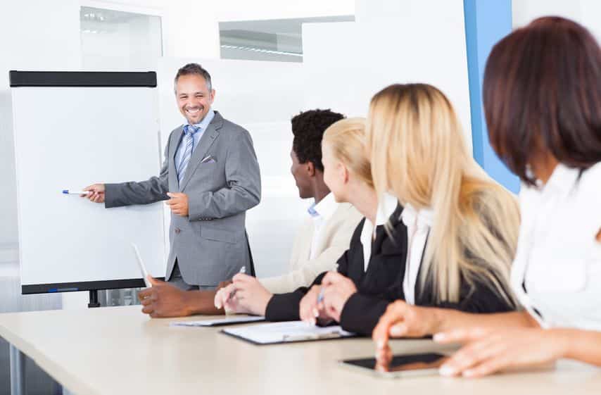 21328368 businesspeople looking at businessman explaining in presentation